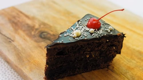 Rich Chocolate Cake Slice with Cherry Topping