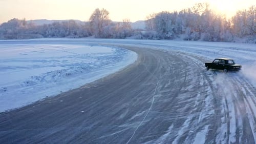 FPV Drone Shot of a Racing Car Sliding on an Ice Track on a Lake in Winter