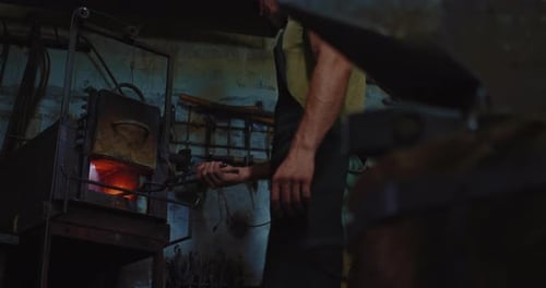 Blacksmith Shaping Hot Metal on Anvil
