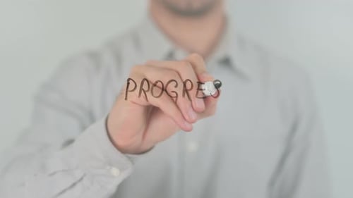 Writing the Word Progress on Clear Surface