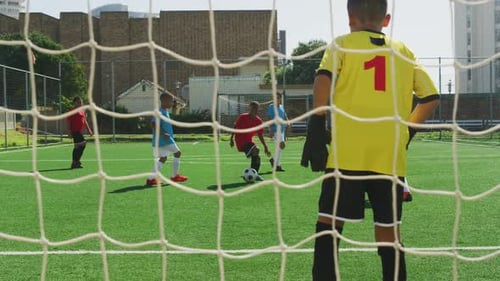 Soccer kids playing in a sunny day