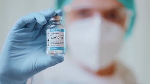 Medical Professional Holding COVID-19 Vaccine Vial