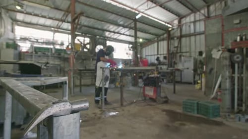 Welder Working on Metal in a Workshop