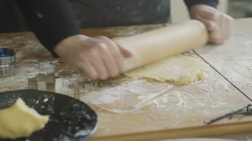 Hands Roll Cookie Dough with Rolling Pin