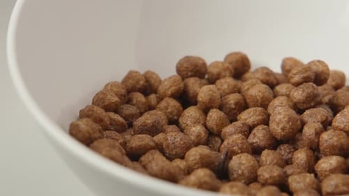Chocolate Cereal Poured into White Bowl