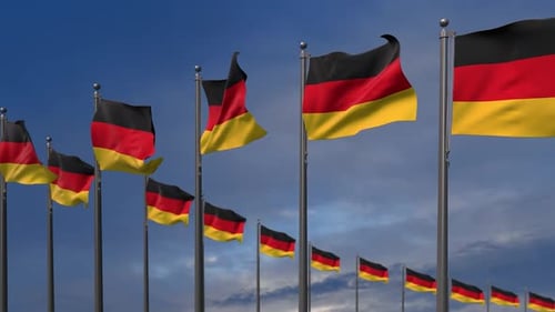 Waving German Flags on Poles with Blue Sky Background