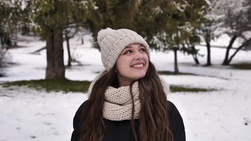 Happy woman walks in the winter forest