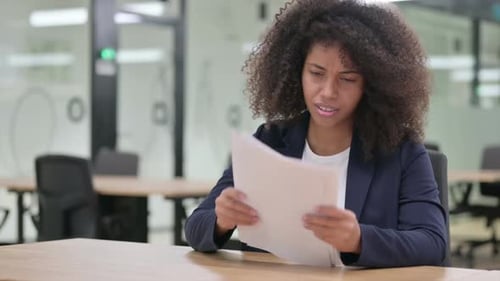 Woman Reviews Documents with Negative Reaction