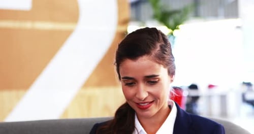 Woman Working on Tablet in Corporate Setting