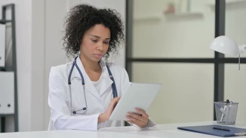 Female Doctor Using Tablet in Modern Office