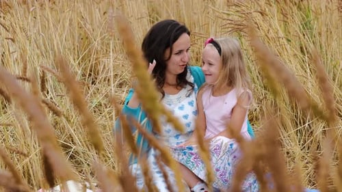 Little Girl with Mom Having Fun Time in a Field