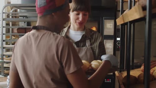 Two Multiethnic Women Working Together in Bakery