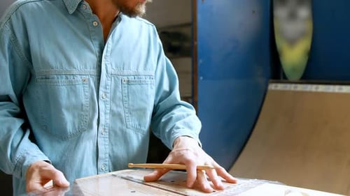 Man making surfboard