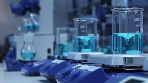 Blue Liquid Stirring in Glass Beakers