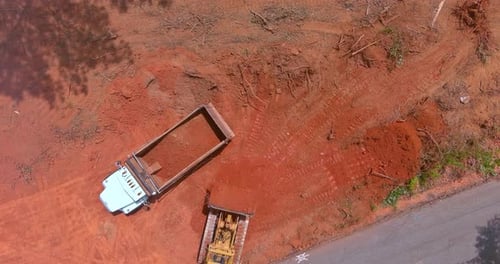Bulldozer Fills Dump Truck with Red Dirt, Aerial