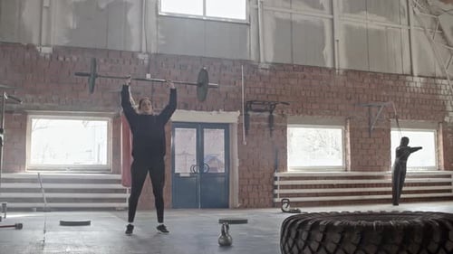 Woman Doing Barbell Raises Over Head