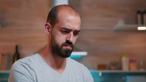 Thoughtful Man Close Up in the Kitchen