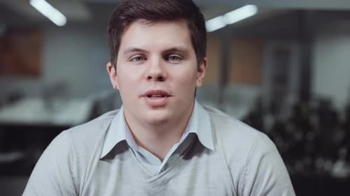 Young Adult Man Speaking in an Office Environment