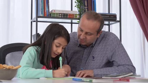 Father Helping Daughter with Homework at Home