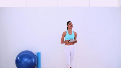 Woman with Tablet in Fitness Setting