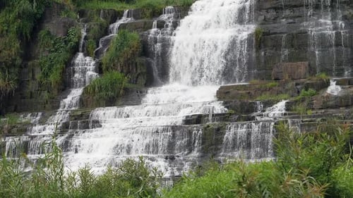 Cascading Waterfall Flows Over Rugged Rocks