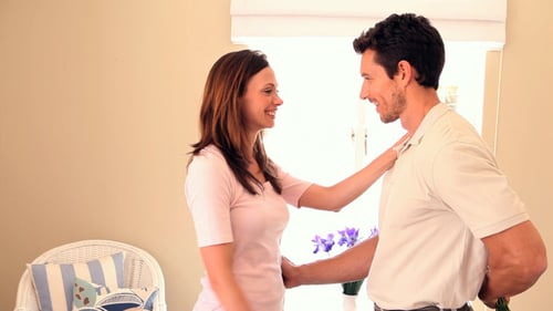 Man Gives Woman a Bouquet of Flowers at Home
