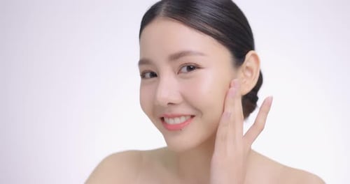 Close Up Of Young Beautiful Asian Woman Touch Her Face Gently With Fingertips.