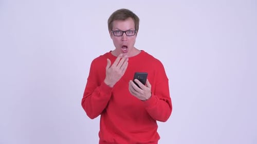 Man is Shocked Looking at His Phone