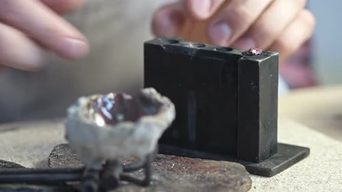 Craftsman Setting Ruby Jewel with Torch and Tools