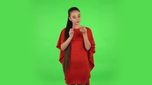 Stylish Woman Filing Nails on Green Screen