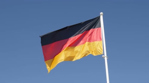 German Flag Waving in the Wind on Blue Sky