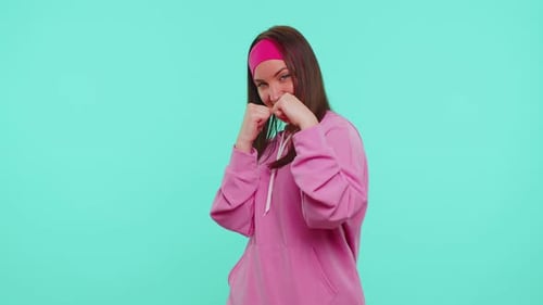 Smiling Young Woman Playfully Throwing Punches