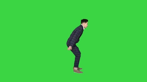Businessman in Suit Makes Back Flip and Shows Thumb Up on a Green Screen, Chroma Key.
