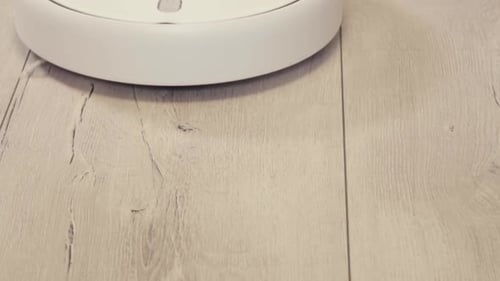 Robot Vacuum Cleaning on Wooden Floor