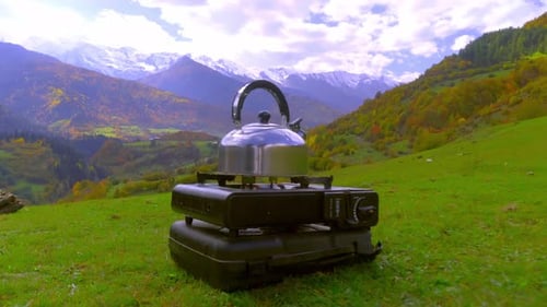 Scenic Mountain Landscape With Kettle and Stove