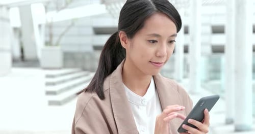 Woman use of mobile phone in city