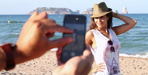 Woman Posing on Beach as Person Takes Photos
