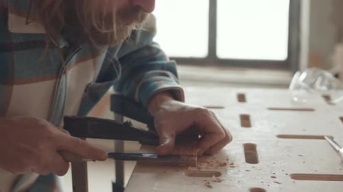 Woodworker Chiseling Wood at Workbench, Close Up
