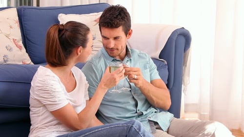 Loving Couple Toasts with White Wine at Home