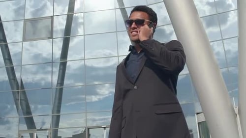 Man in Suit Talking on Phone