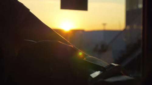 Person Uses Smartphone During a Beautiful Sunrise