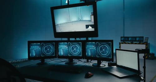 Futuristic Computer Monitors Displaying Complex Data in Dark Room