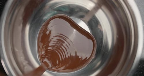 Smooth Liquid Chocolate Mixing in a Metal Bowl