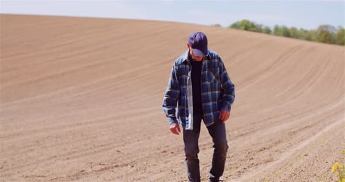 Agriculture Farmer Walking on Field.