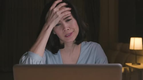 Stressed Woman Working Late on Laptop at Home