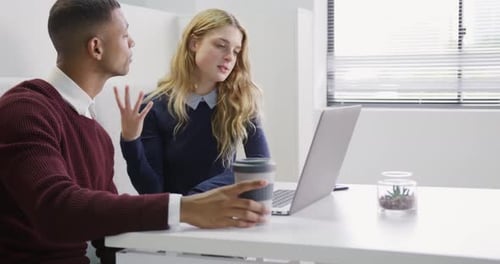 Man and woman discussing at the office