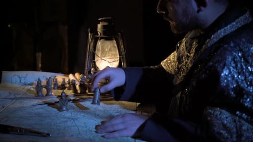 Mysterious Man Strategizing with Chess Pieces on Map