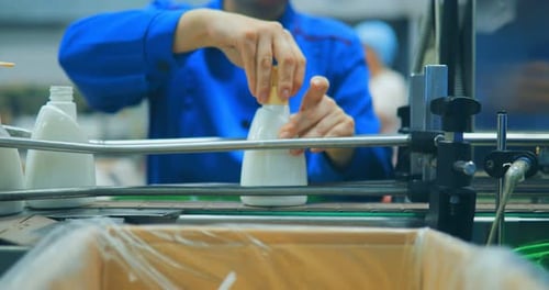 Row of White Cosmetics on a Conveyor Line