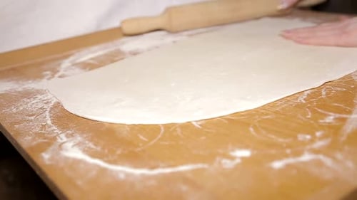 Preparing Dough on a Wooden Surface