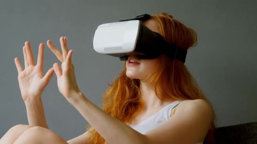 Woman Using Virtual Reality Headset at Home